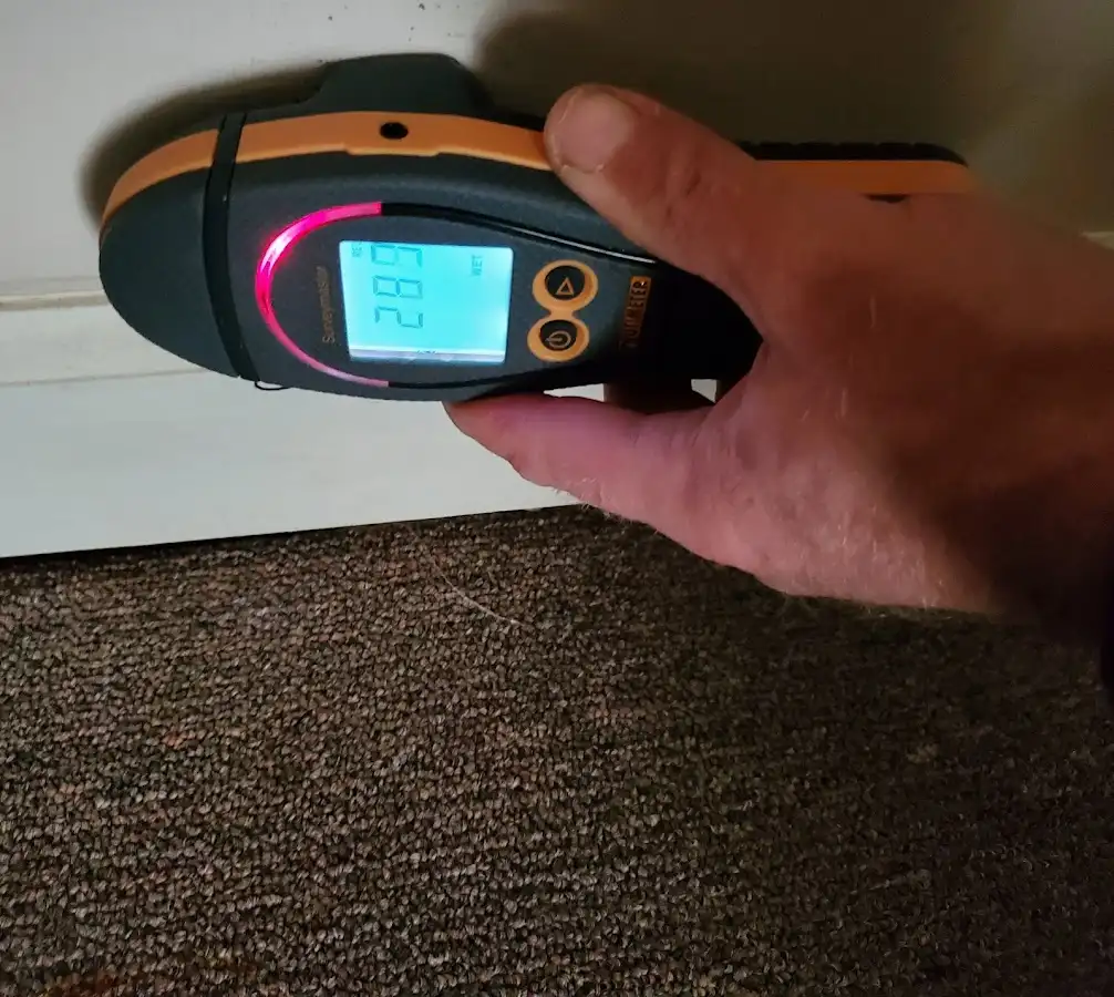 Moisture detection at baseboard during Storm Damage Restoration in Torrington